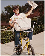 Boy delivers newspaper